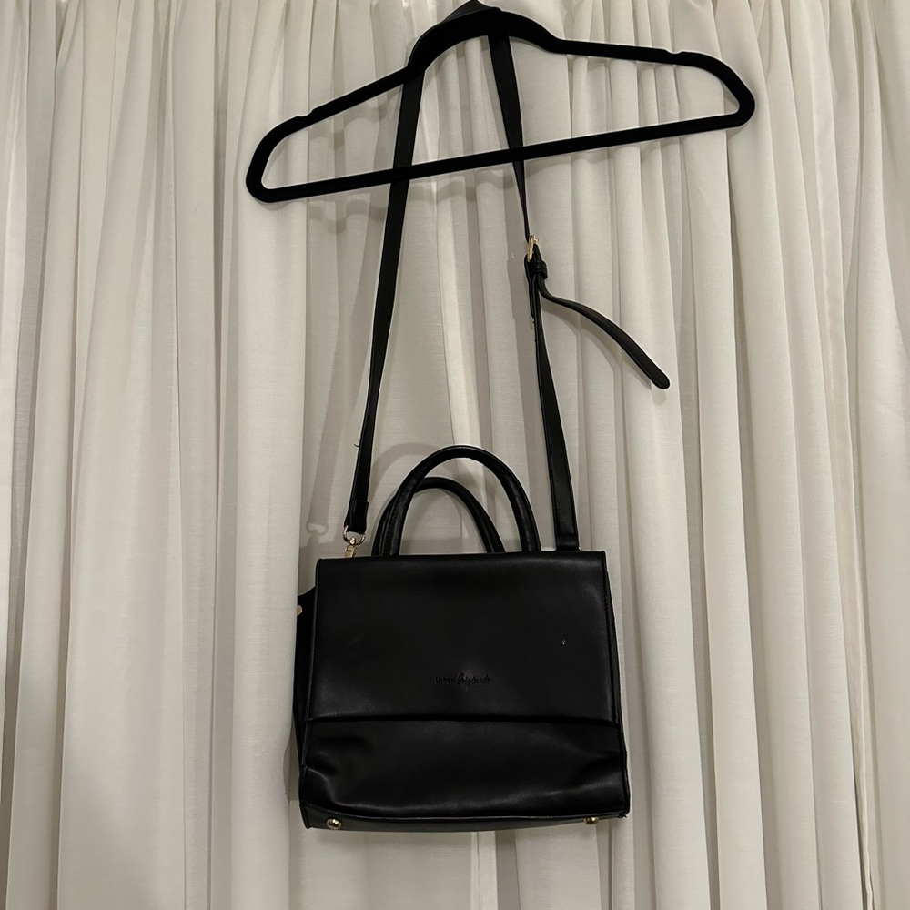 Black purse with gold metal zipper and details